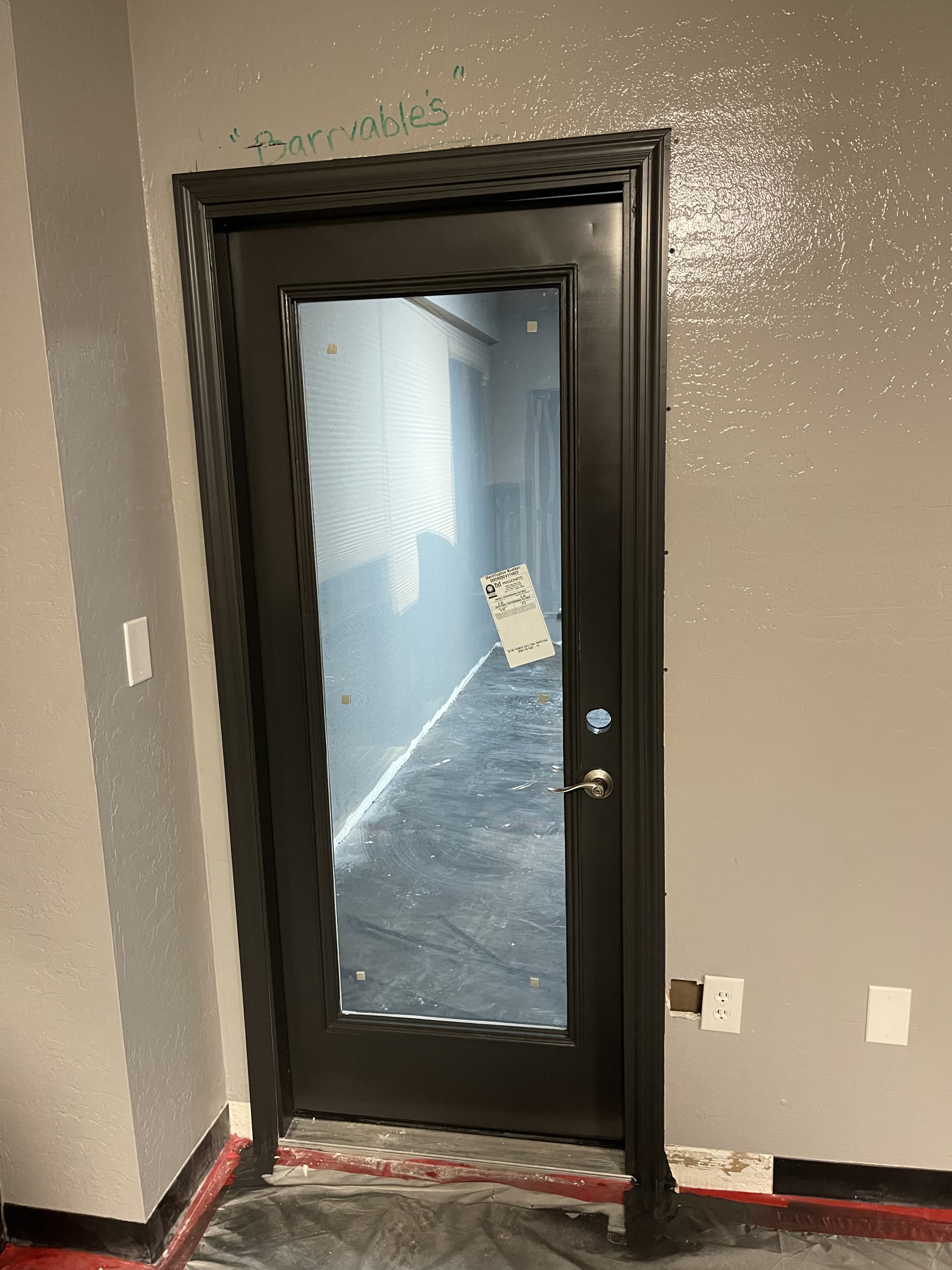 New black-framed doorway connecting the PHP office to the studio buildout
