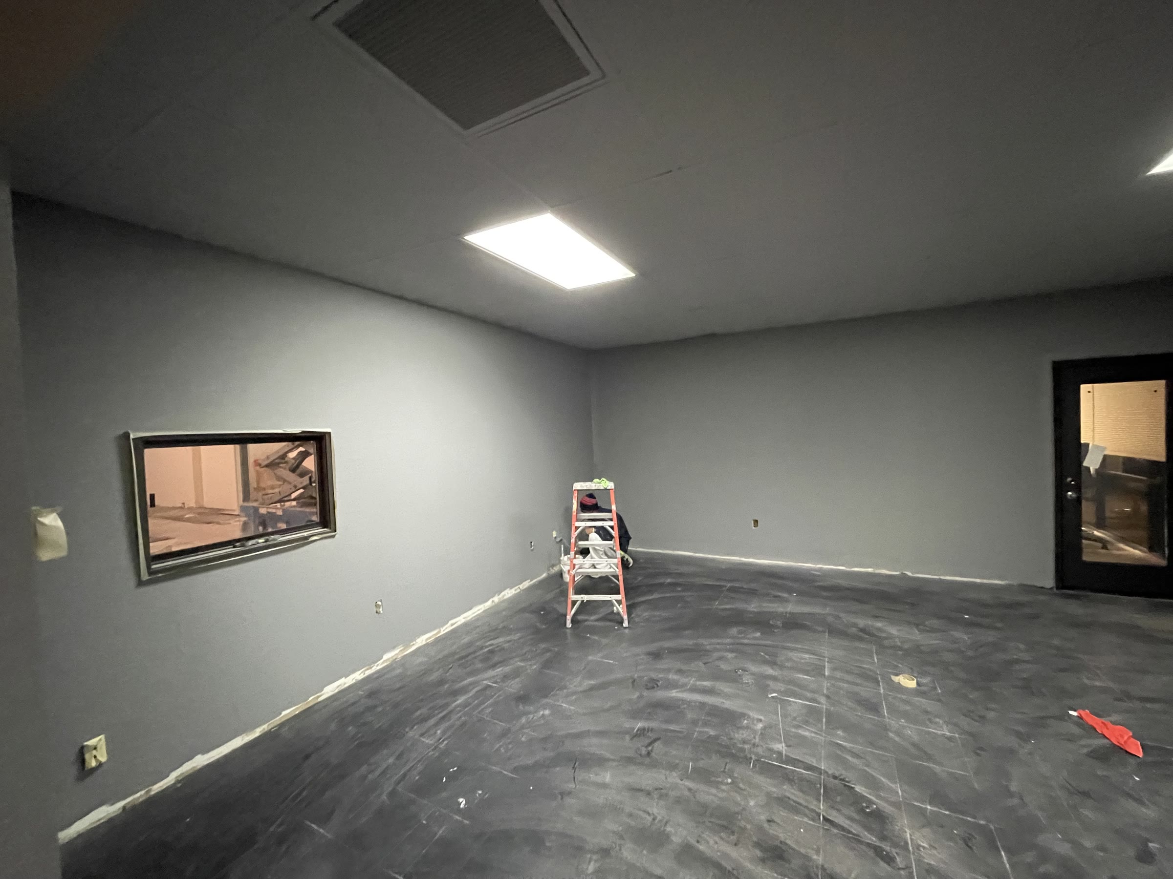 Studio buildout showing new lighting, gray paint and an interior window
