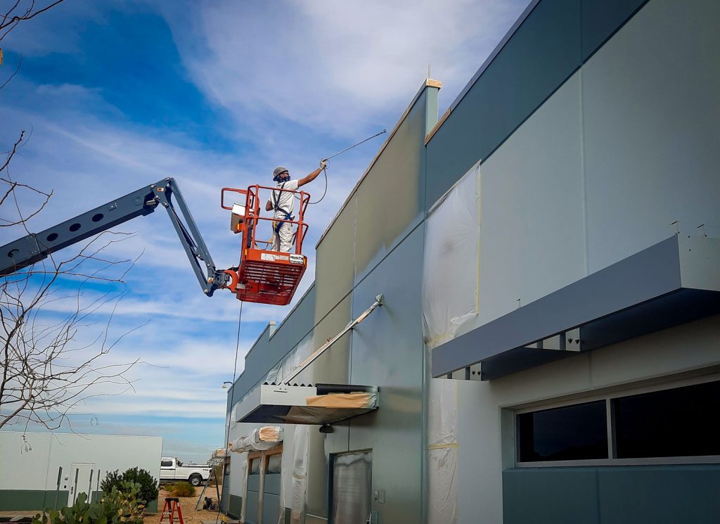 Bucket lift to perform commercial exterior painting