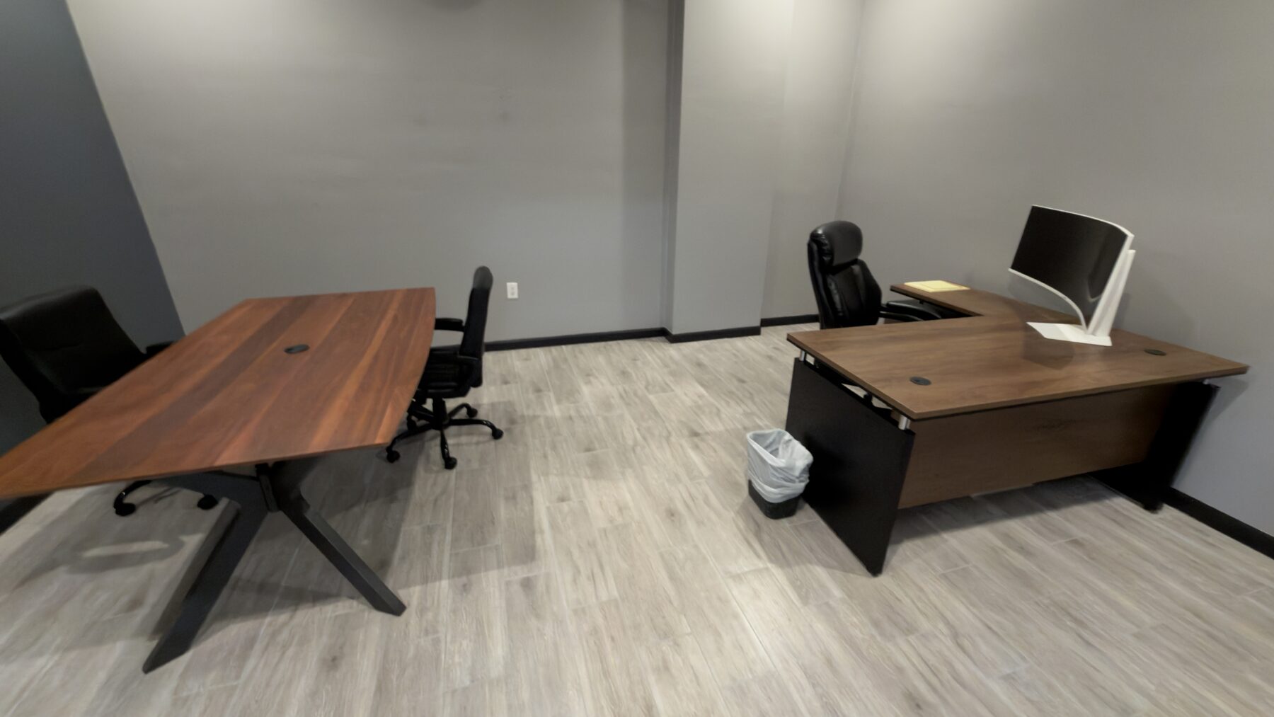Tommy Miller’s furnished office at PHP Commercial Painting, with a desk and separate meeting table.
